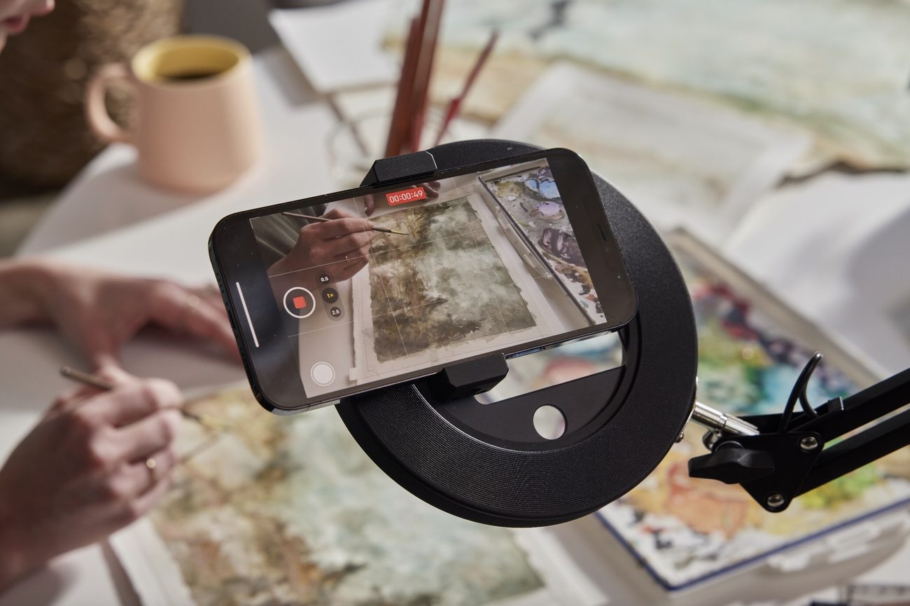 Creator filming a painting from above with CANVAS